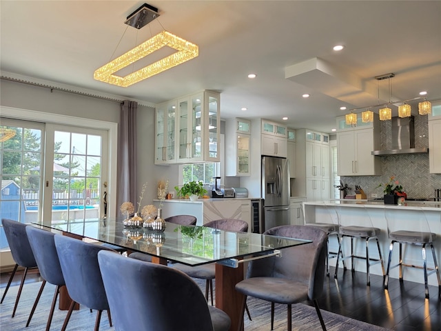 dining room featuring wine cooler, dark hardwood / wood-style flooring, and a wealth of natural light