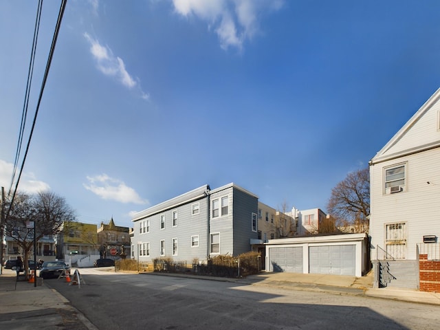 view of street with sidewalks, a residential view, and curbs