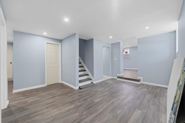 basement with dark hardwood / wood-style flooring