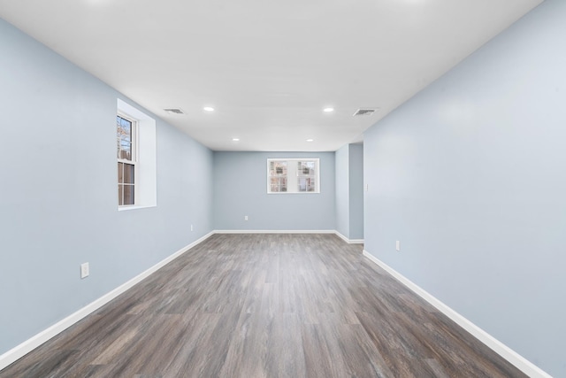 unfurnished room with dark wood-type flooring