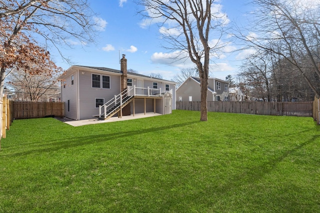 rear view of house with a yard and a patio