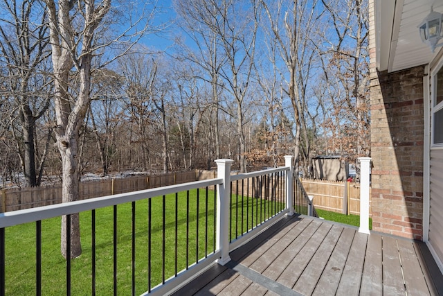 wooden terrace featuring a yard