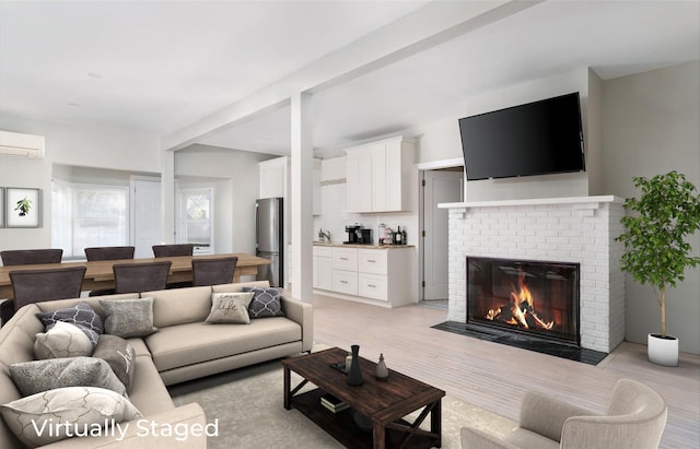 living room featuring a wall unit AC and a brick fireplace