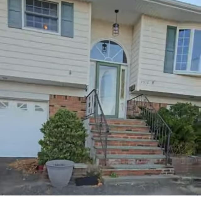 view of exterior entry featuring a garage