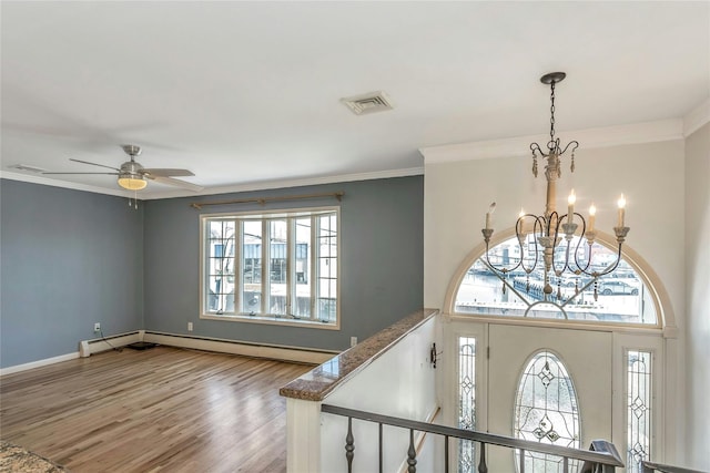 foyer entrance featuring crown molding, ceiling fan with notable chandelier, and light hardwood / wood-style flooring