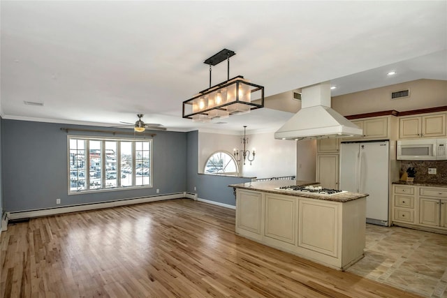 kitchen with white appliances, island range hood, a center island, and cream cabinetry