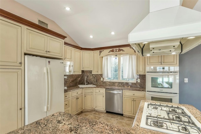 kitchen featuring sink, white appliances, tasteful backsplash, island range hood, and cream cabinetry