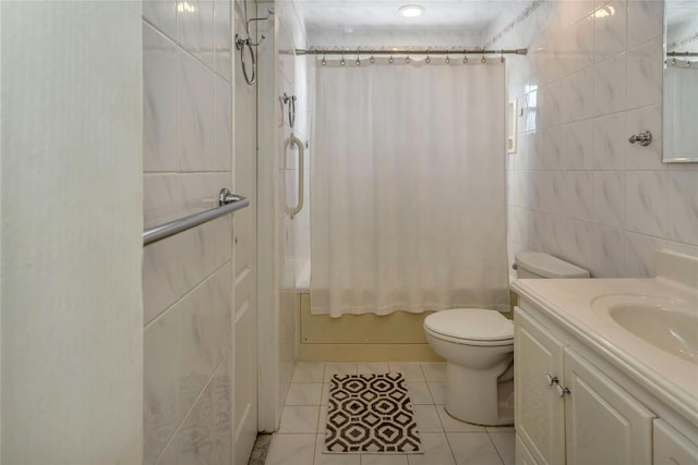 full bathroom featuring toilet, tile walls, vanity, shower / bath combo with shower curtain, and tile patterned flooring