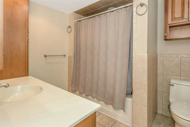 full bathroom featuring tile patterned floors, toilet, shower / tub combo, tile walls, and vanity