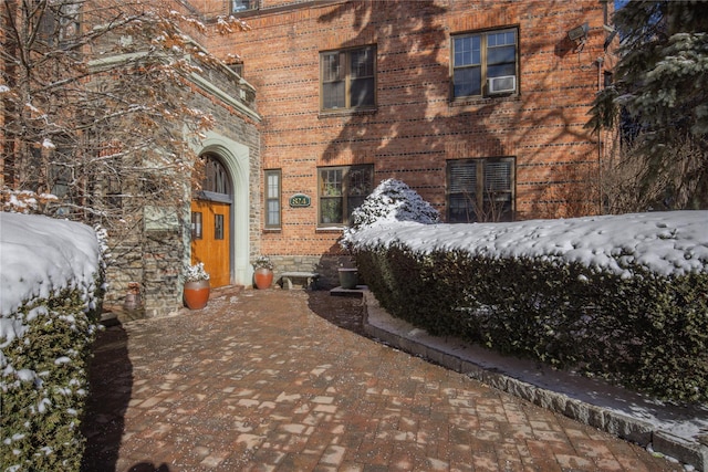 view of snow covered property entrance