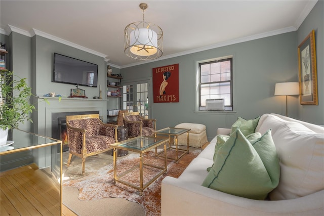 living room featuring hardwood / wood-style flooring and crown molding