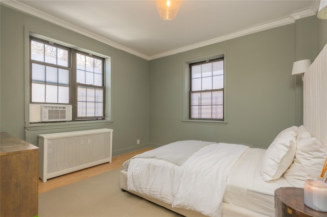 bedroom with crown molding, radiator, cooling unit, and light wood-type flooring