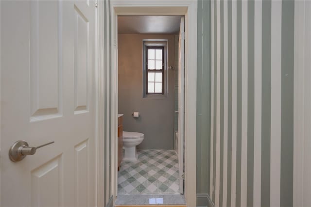 bathroom featuring vanity, toilet, and walk in shower