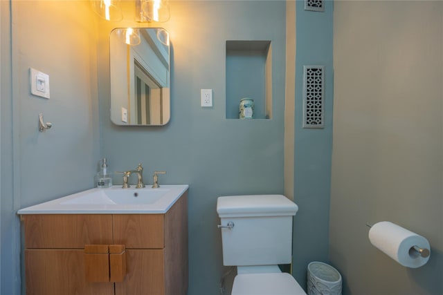 bathroom featuring vanity and toilet