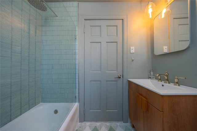 bathroom featuring tiled shower / bath combo and vanity