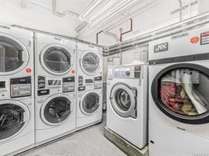 laundry room with stacked washing maching and dryer and washing machine and dryer