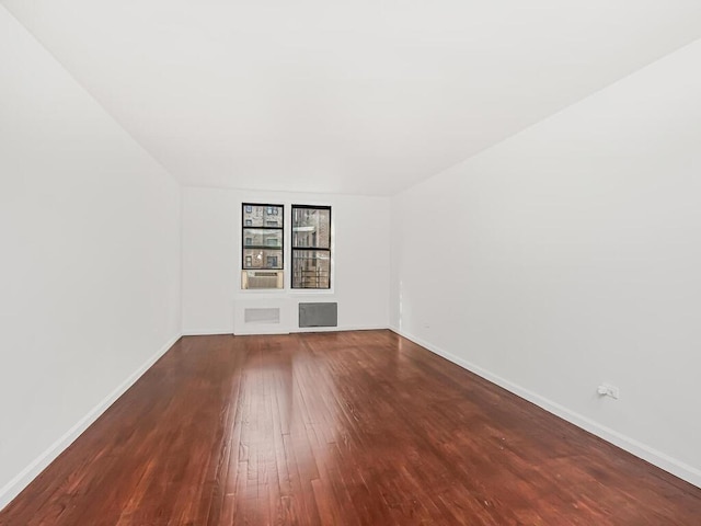 spare room with wood-type flooring