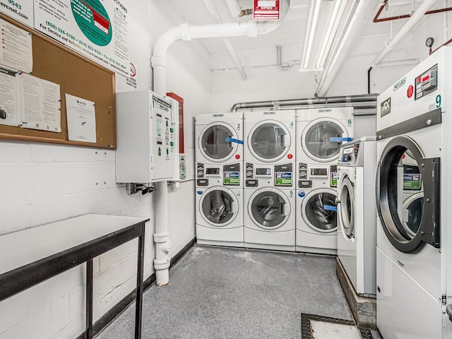 clothes washing area featuring stacked washing maching and dryer and washer and clothes dryer