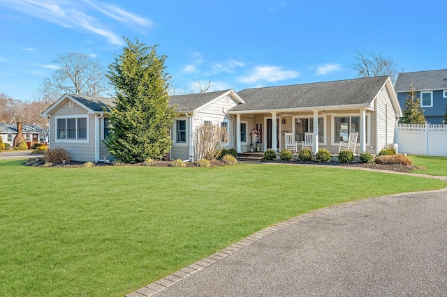 ranch-style home with covered porch and a front yard