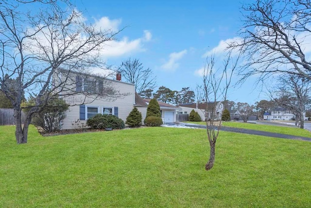 view of front of property featuring a garage and a front lawn