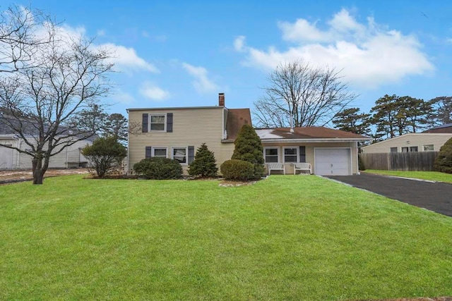 view of front of home featuring a garage and a front yard