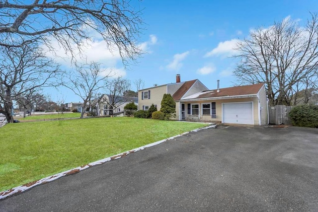 view of front of property with a garage and a front yard