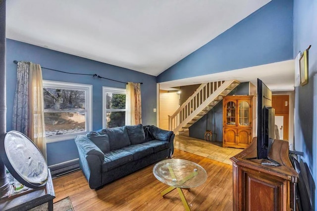 living room featuring lofted ceiling and light wood-type flooring