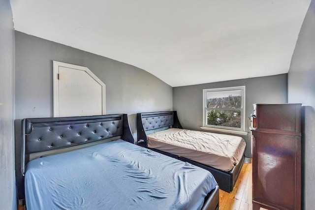 bedroom featuring vaulted ceiling and light hardwood / wood-style floors