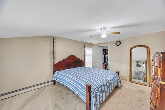 carpeted bedroom with baseboard heating, ceiling fan, and a closet