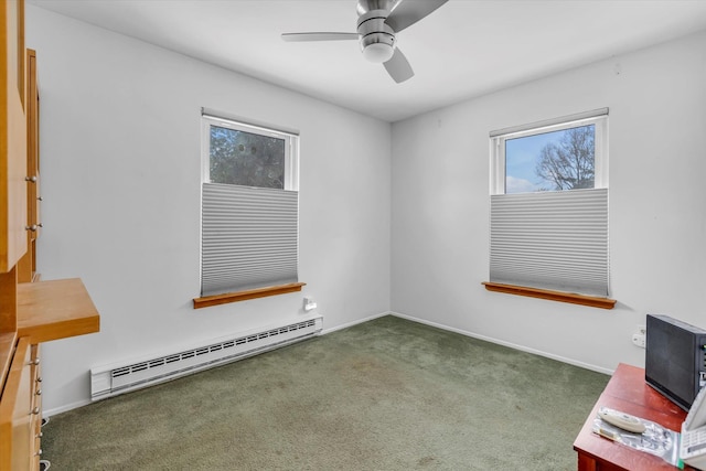 carpeted spare room with ceiling fan and baseboard heating