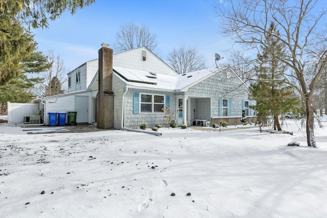 view of snow covered rear of property