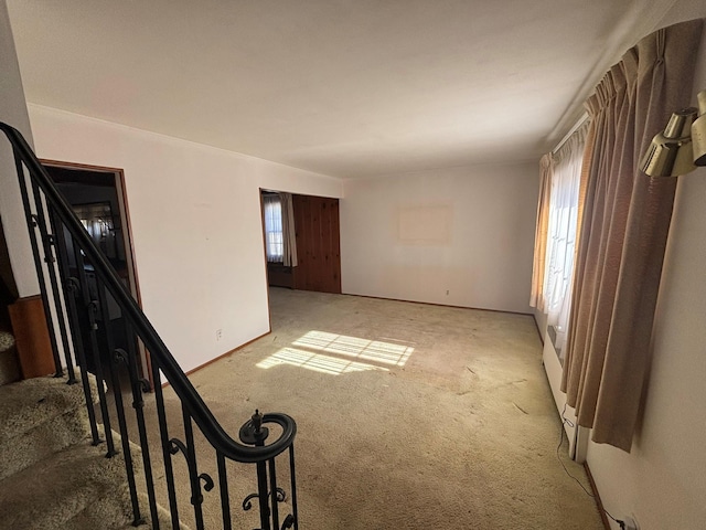 empty room with a healthy amount of sunlight and light colored carpet