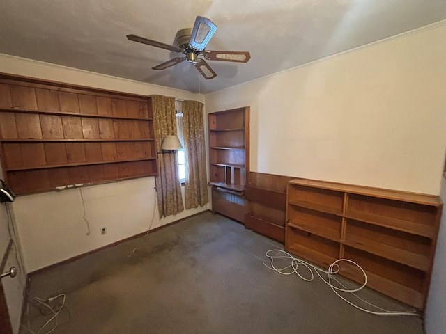 unfurnished bedroom with dark colored carpet and ceiling fan