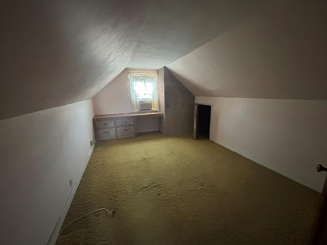 bonus room with light colored carpet and lofted ceiling