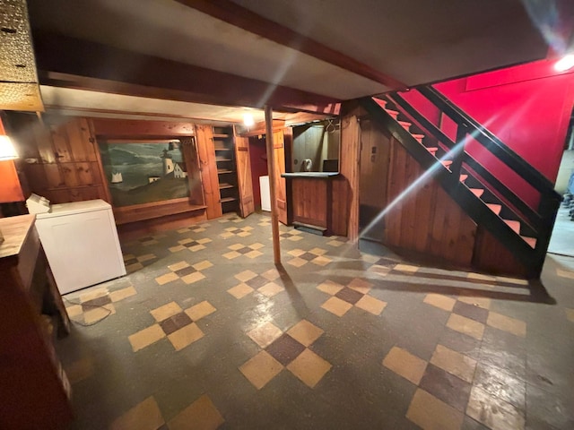 interior space with washer / clothes dryer, refrigerator, and wood walls