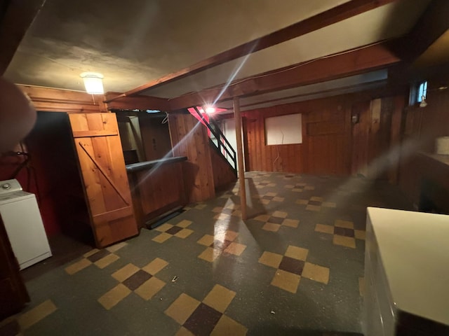 basement with washer / dryer and wood walls