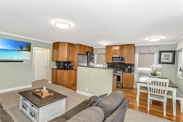 carpeted living room with sink and crown molding