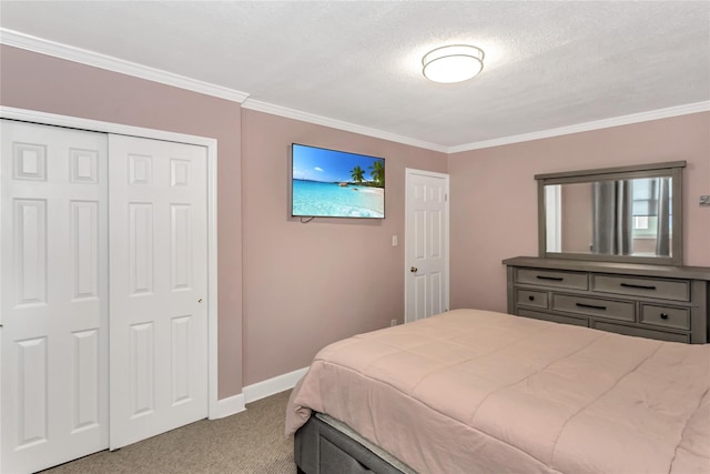 bedroom featuring a textured ceiling, a closet, ornamental molding, and light colored carpet