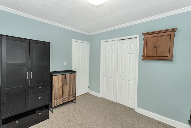 bedroom featuring light carpet, a textured ceiling, and crown molding