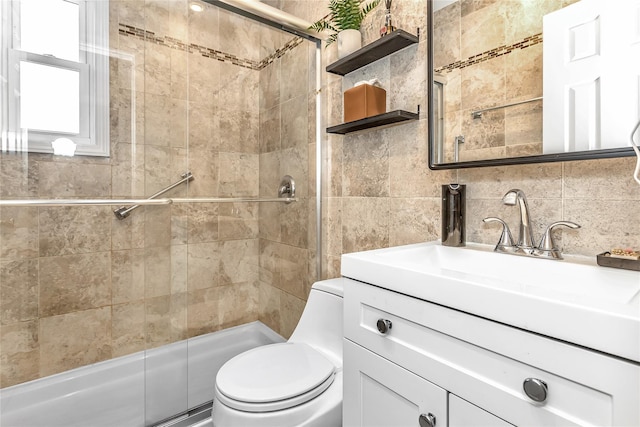 bathroom featuring a shower with shower door, vanity, decorative backsplash, and toilet