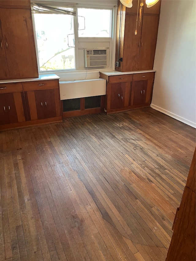 interior space featuring dark wood-type flooring and cooling unit