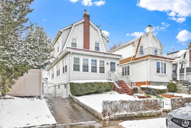 view of snow covered rear of property