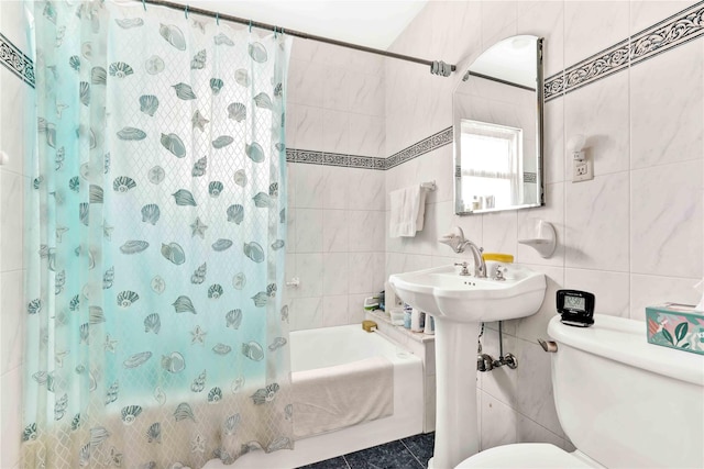 bathroom with tile walls, toilet, and shower / bath combination with curtain