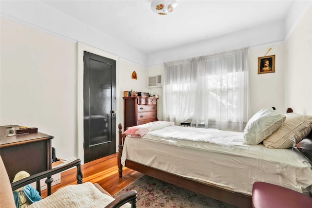 bedroom with hardwood / wood-style floors