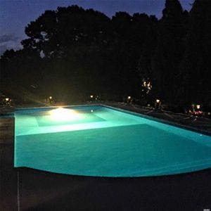 view of pool at twilight