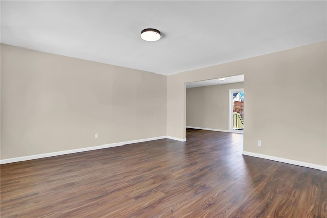 spare room with dark hardwood / wood-style floors