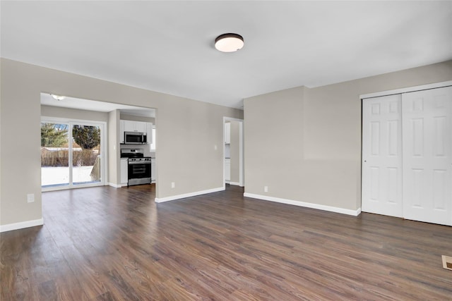 unfurnished living room featuring dark wood-type flooring