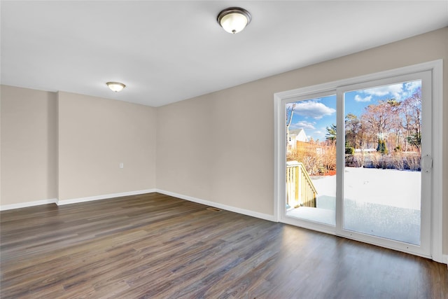 empty room with dark hardwood / wood-style floors