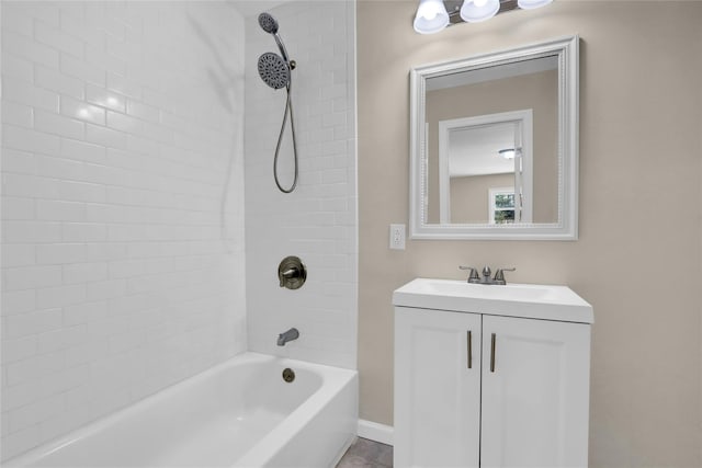 bathroom featuring tiled shower / bath combo and vanity