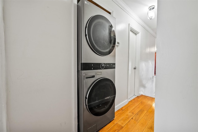 washroom featuring stacked washer / dryer and light wood-type flooring